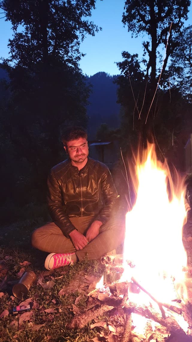 Travelers gathered around a bonfire