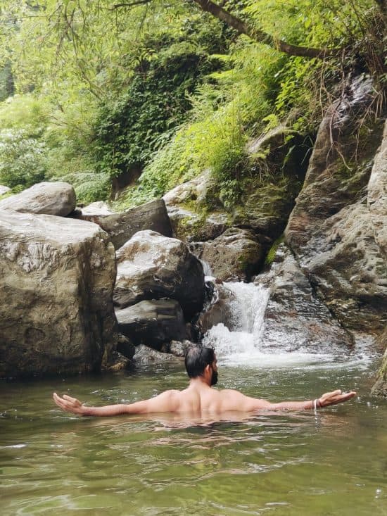 A traveler enjoying a peaceful water dipping session