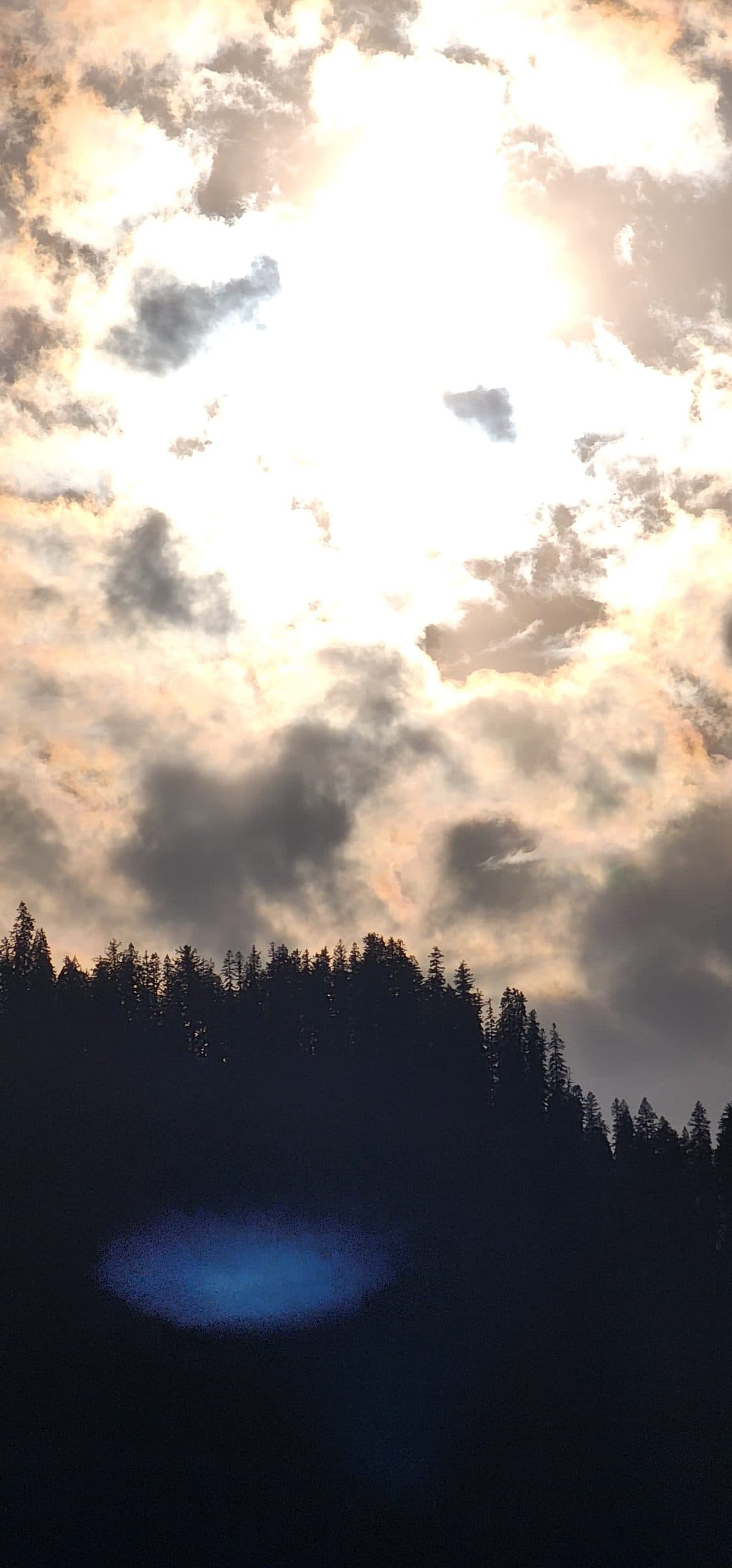 A picturesque waterfall cascading through the lush green hills of Jibhi Valley, Himachal Pradesh, India